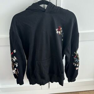 Beautiful black sweater with some bird/flowers art.